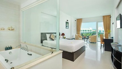 Bồn tắm đặt cạnh tấm kính nhìn ra phòng ngủ