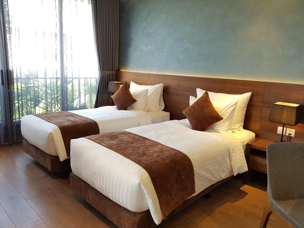 Giường đôi tại Phòng Deluxe Double/Twin with Balcony khách sạn Orchid Boutique